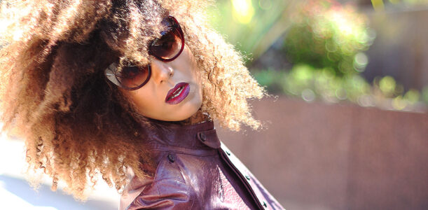 Ndoema is rocking a cropped leather jacket by Diesel , Tom Ford lip color in bruised plum and House of Harlow 1960 Chelsea Cateye Sunglasses