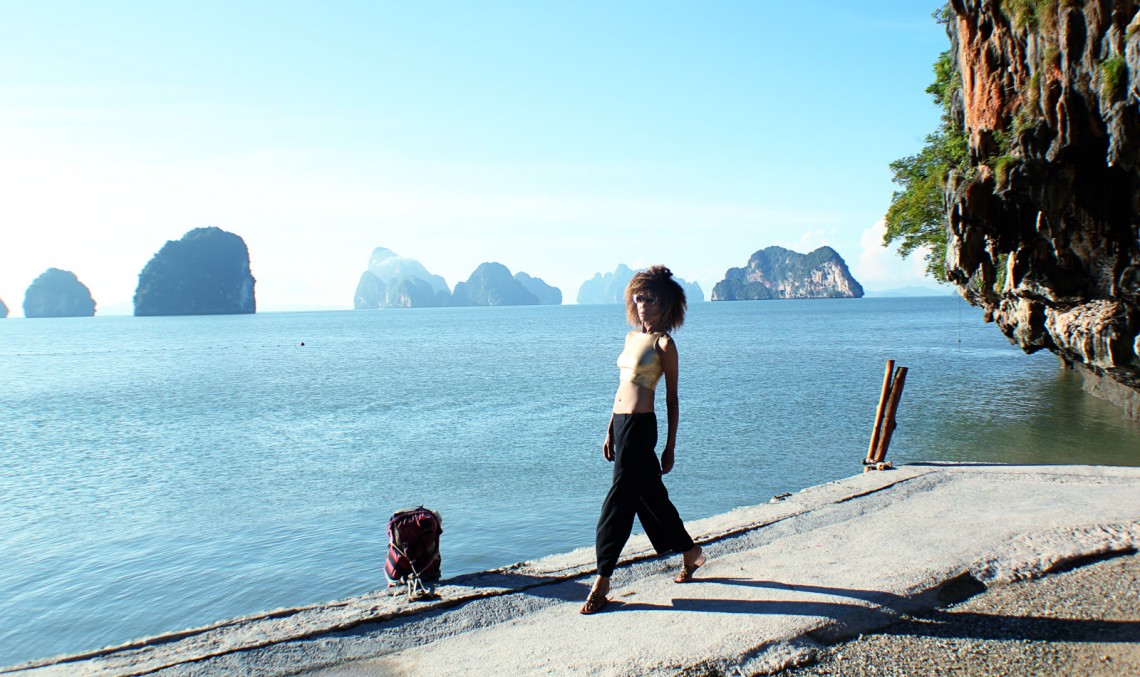The Global Girl Travels: Ndoema sports a gold crop top with cat eye sunglasses while exploring beautiful James Bond Island in the Phang Nga Bay, Thailand.