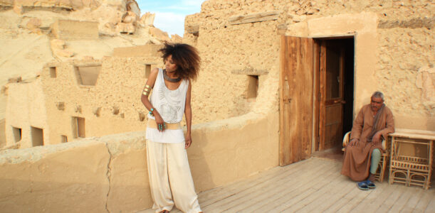 The Global Girl Daily Style: Ndoema channels boho chic style in ethnic-inspired beaded tank by Antik Batik, silk palazzo pants by Robert Rodriguez, jeweled sandals by Miu Miu and her own collection of tribal jewelry. Photographed at the Adrère Amelia luxury eco-friendly desert resort at Siwa Oasis, Egypt.