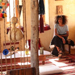 The Global Girl Travels: Ndoema at Talist, a Berber-style luxury and eco-friendly resort at Siwa Oasis, Egypt. Ndoema sports a high-waist maxi skirt by Vivienne Westwood with a vintage embellished cropped top and jeweled stiletto heels.