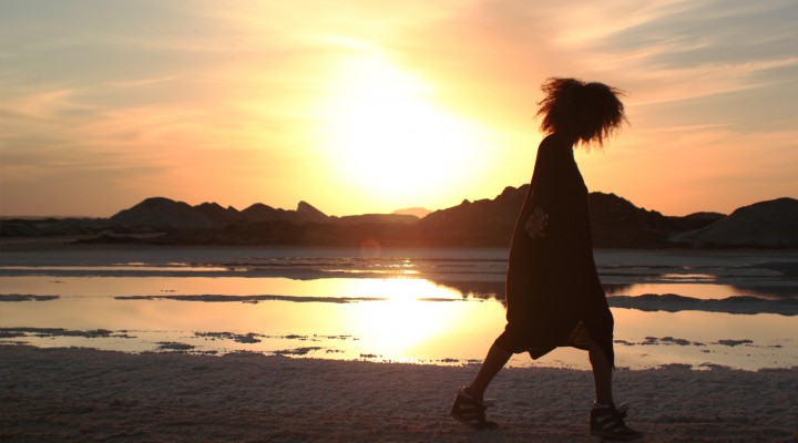 The Global Girl Travels: Ndoema at a local salt mine against the blazing North African sunset, at Siwa Oasis, Egypt.