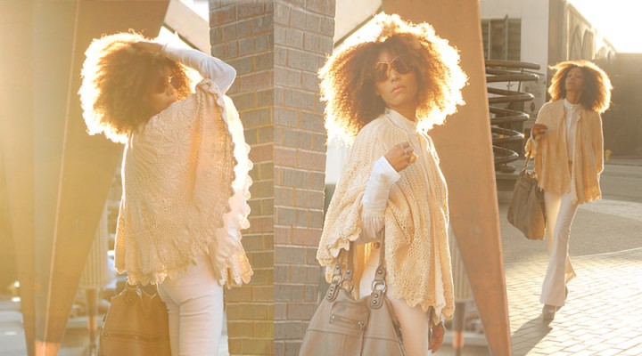 The Global Girl Daily Style: Ndoema rocks a seventies inspired boho look in J Brand bell bottom jeans, a vintage crochet cape, Pour La Victoire platform booties, Vintage Victorian lace blouse, Linea Pelle leather tote and Vintage oversized monobrow shield sunglasses.