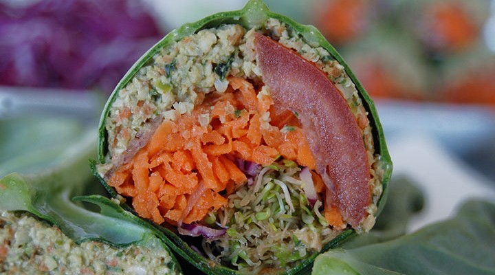 The Global Girl Raw Vegan Recipes: Falafel Burger Wrap in a collard creen Leaf with carrot, sprouts, tomato, red cabbage and red onion.
