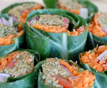 The Global Girl Raw Vegan Recipes: Veggie Wrap with Pumpkin Seed & Mint Patty in a collard green leaf with tomato, shredded carrot, red onion and sprouts.